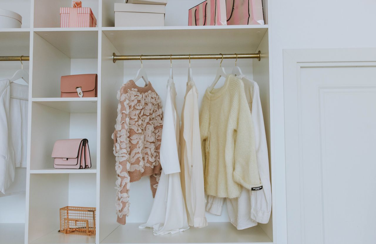services-03 Neat closet showcasing white and pink clothes and accessories for a chic, clean look.